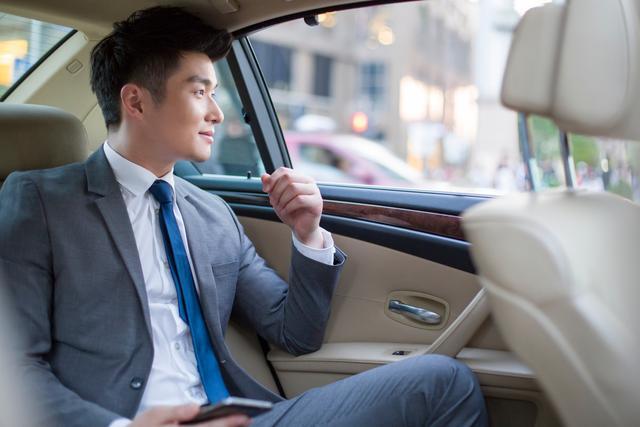 Businessperson sitting in corporate car