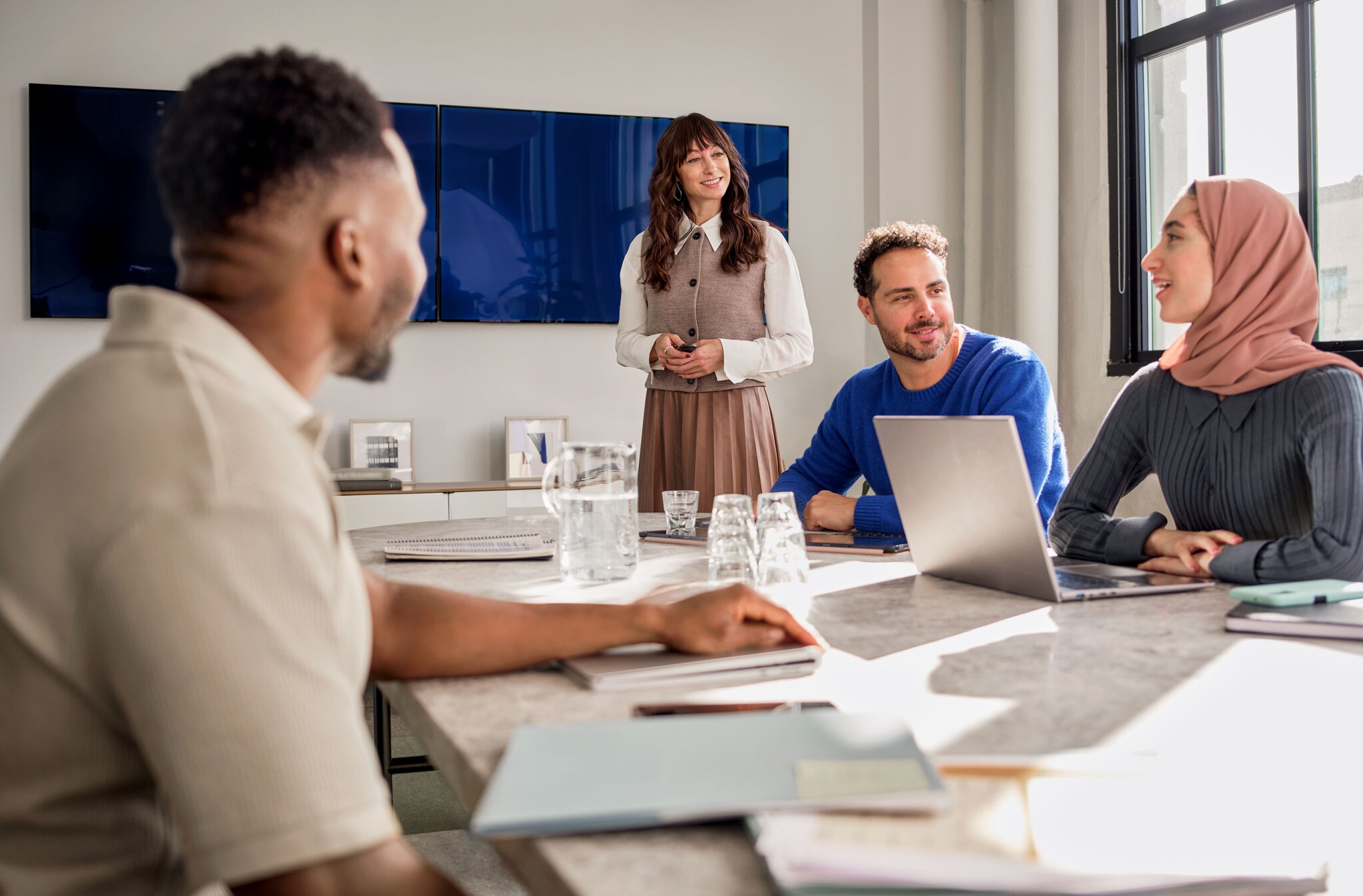A group of colleagues having a meeting in an office conference room.