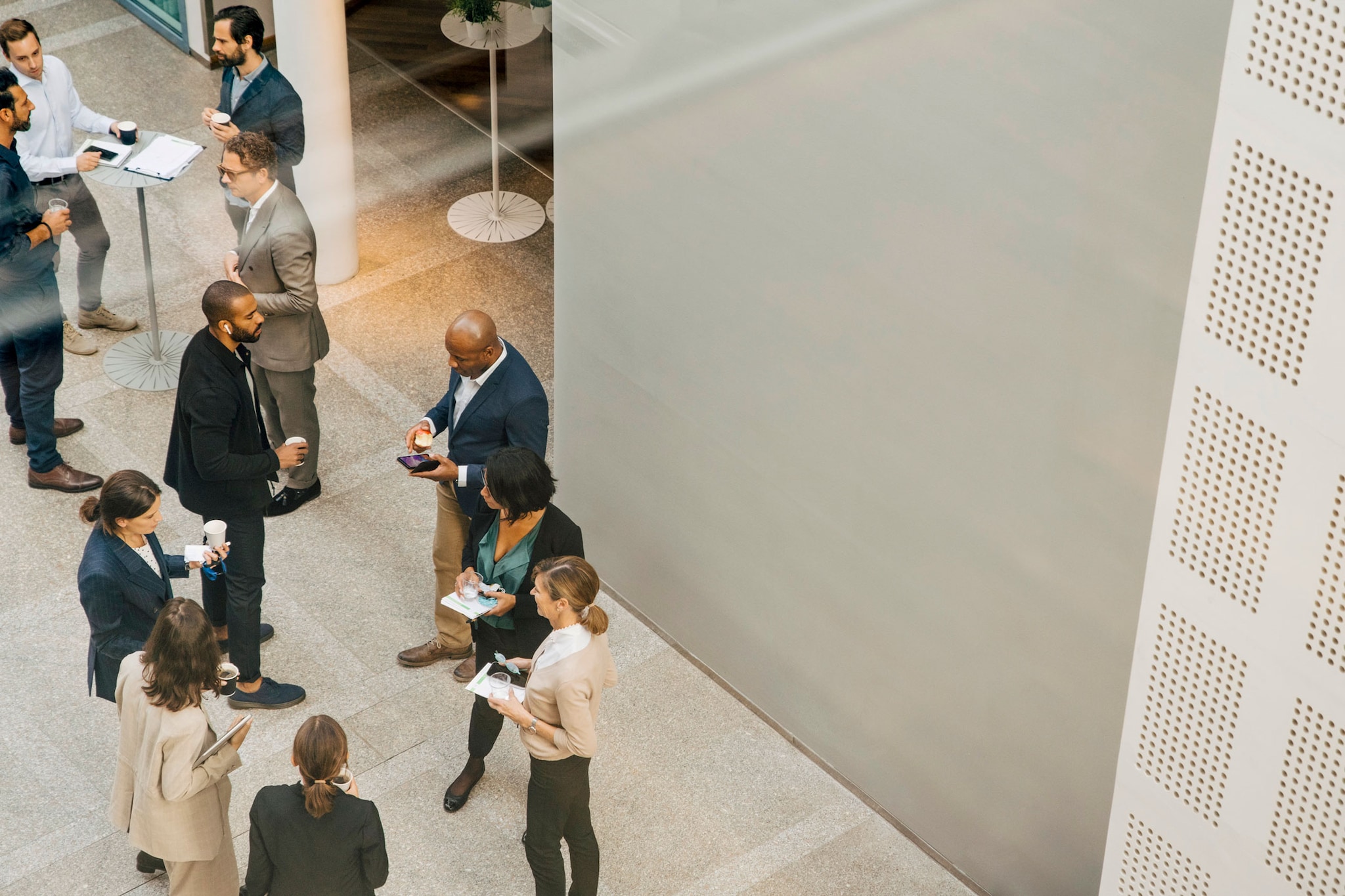 Aerial view of a group of colleagues casually talking/networking at a company event
