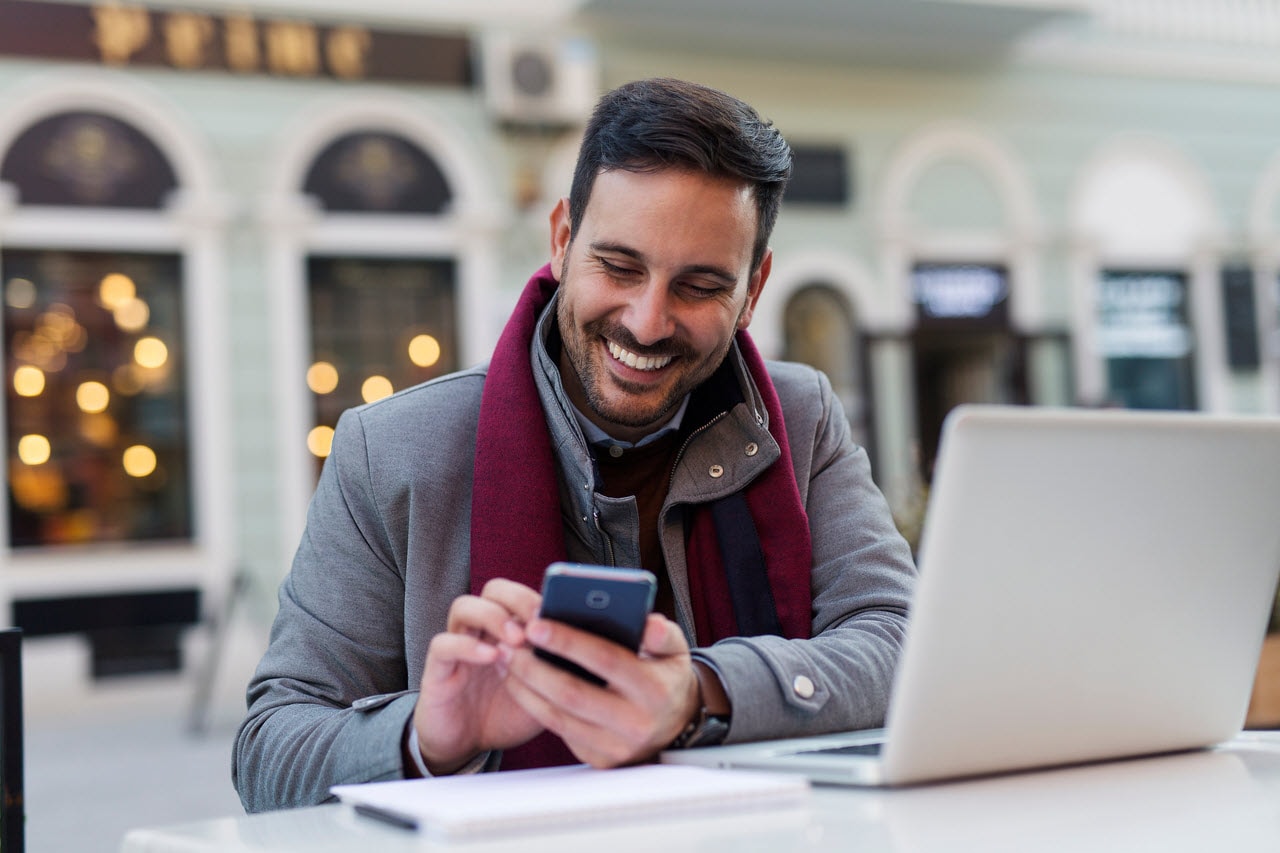 Man reviewing financial activity on a laptop, representing identity monitoring and alerts in CreditSecure