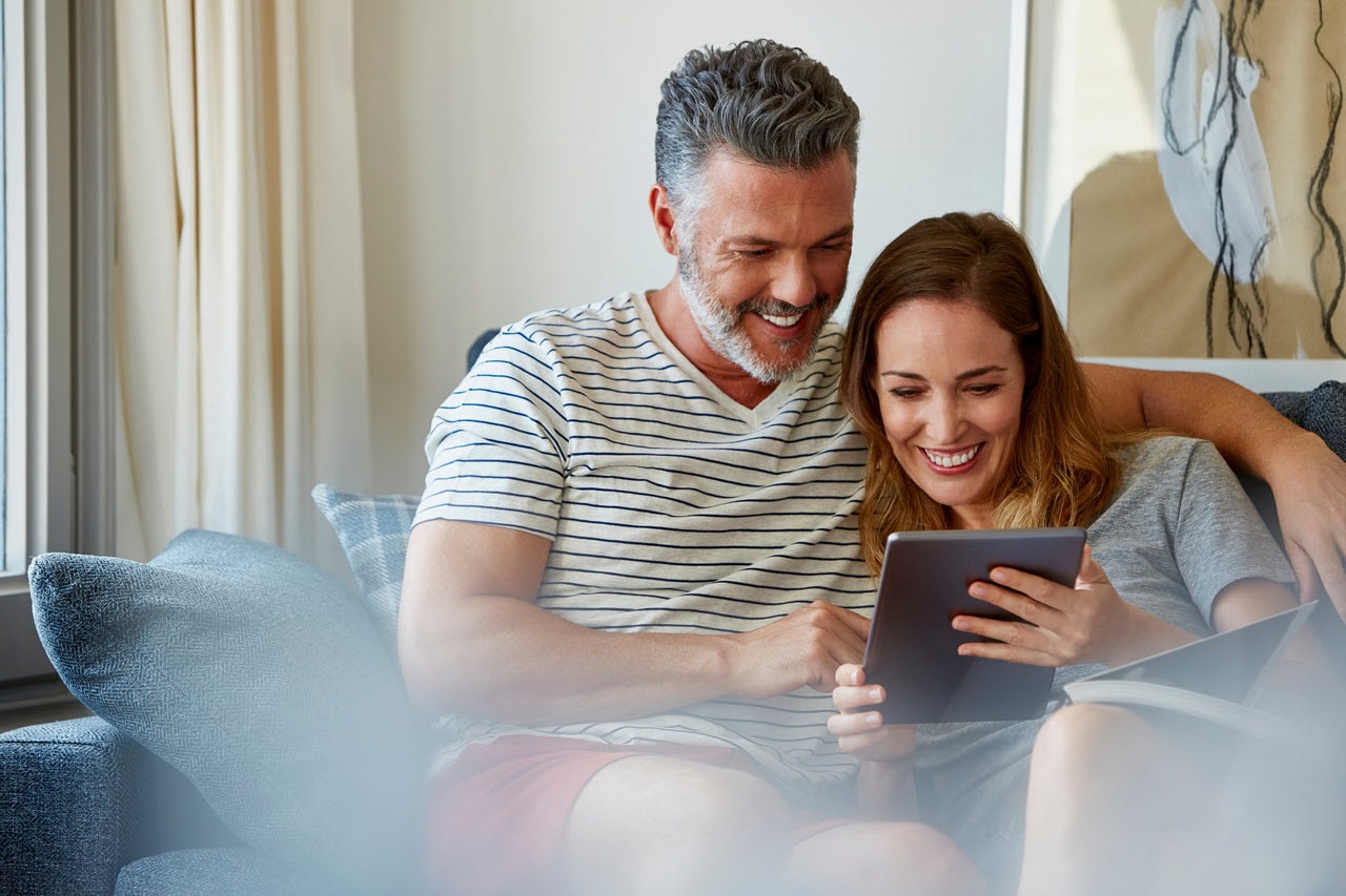 Couple reviewing personal information together on a tablet, representing identity protection and shared financial awareness with CreditSecure