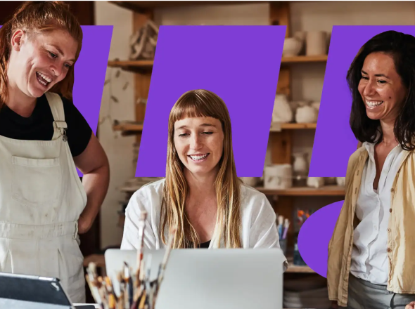 Three people looking at a laptop