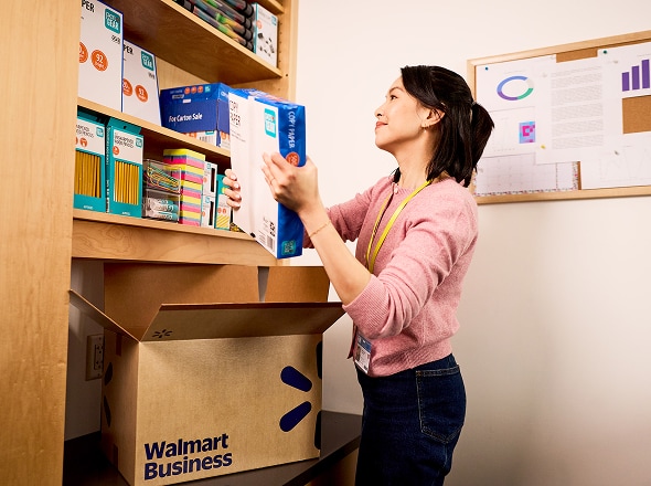 Woman unpacking business supplies from Walmart box