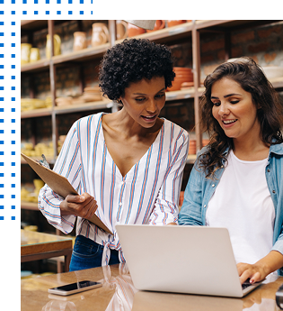 Two people looking at a laptop