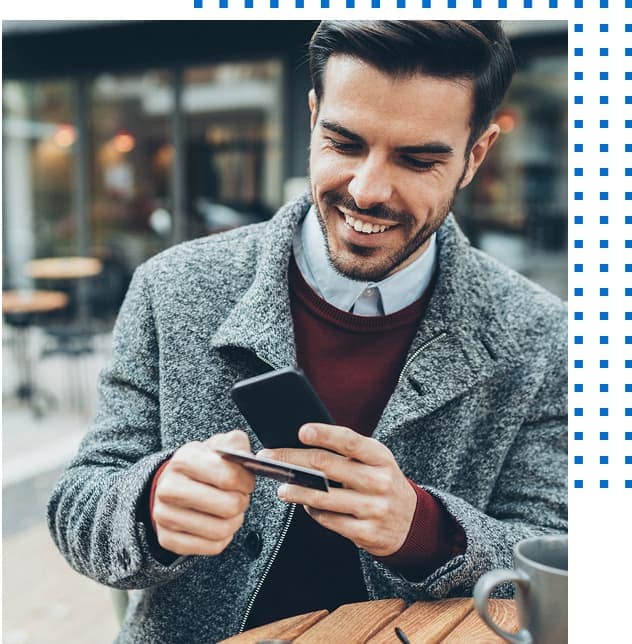 Person holding cell phone and credit card