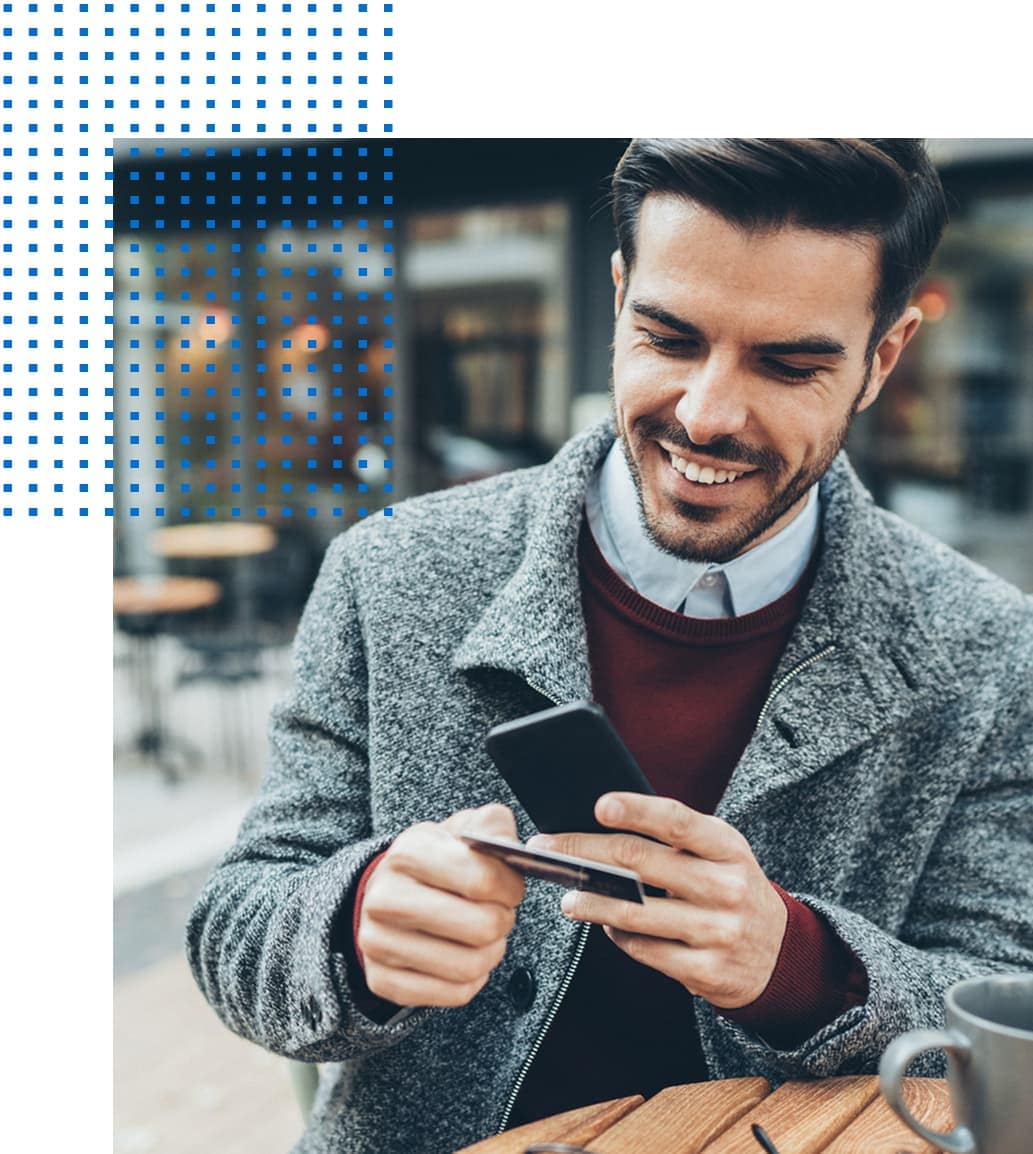 Person holding cell phone and credit card