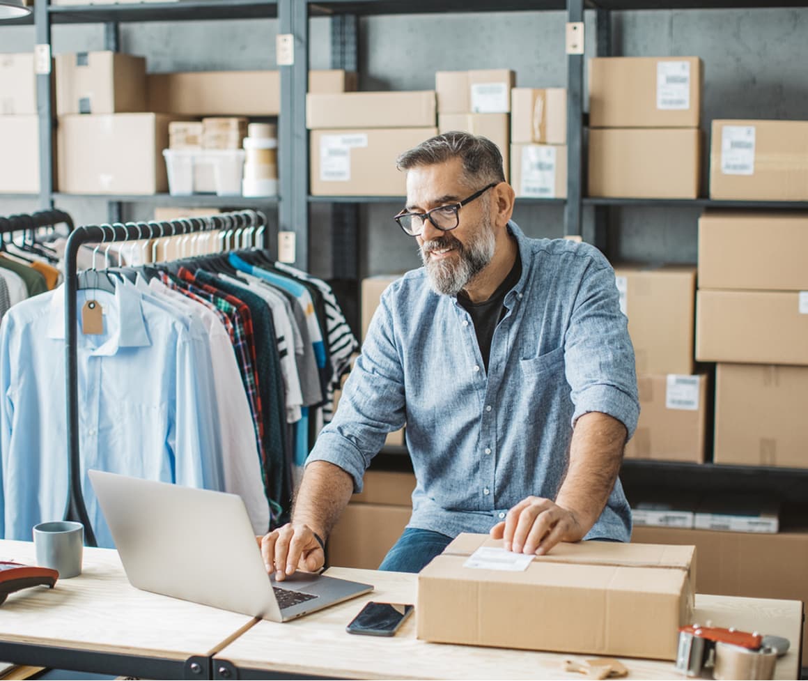 Person using a laptop to fulfill an order