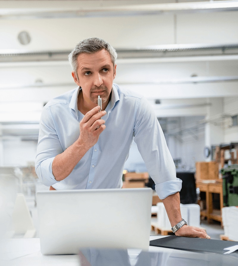Man with a laptop in an open office setting