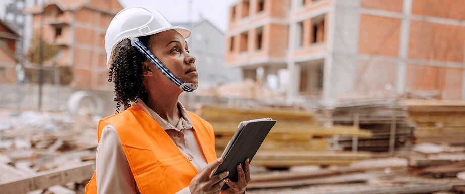 Woman in a hard hat and tablet at a construction site