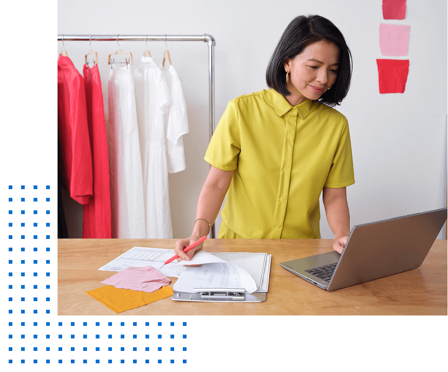 Small business owner completes business paperwork with her laptop