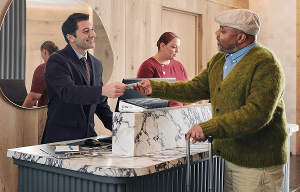 A man checks into a boutique hotel
