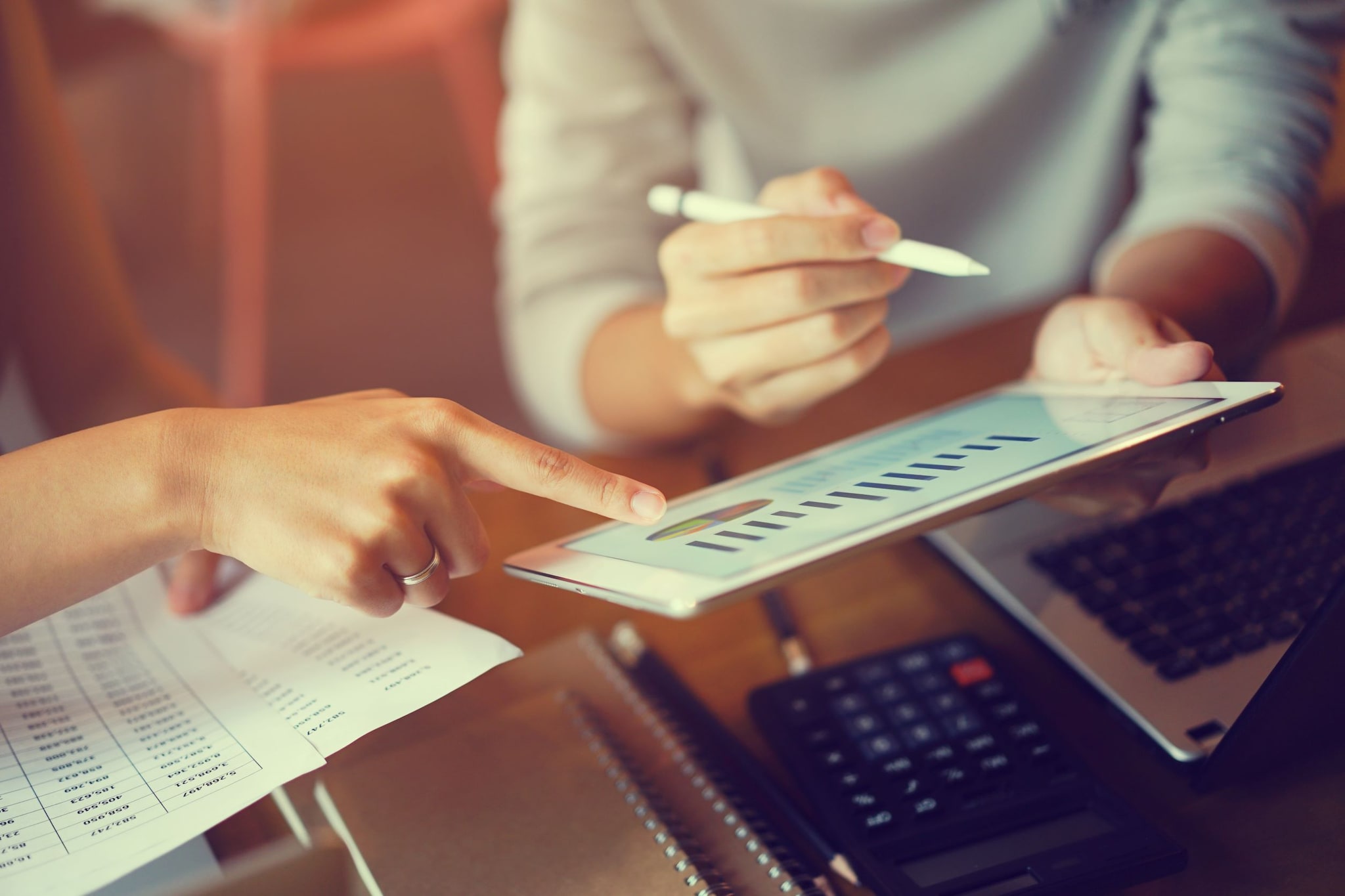 two people looking at data on a tablet device