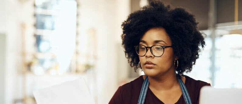 Female business owner looking at report