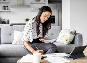 small business owner sitting at table and looking at laptop