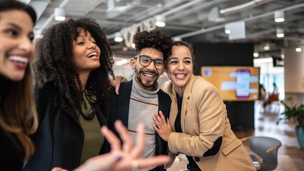 Four people standing together for a picture