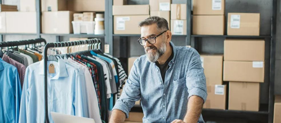 Person in warehouse looking at laptop