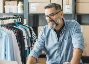 Person in warehouse looking at laptop