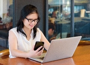 Woman standing with laptop