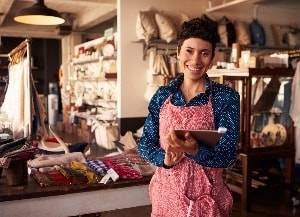 Woman standing in store holding a tablet