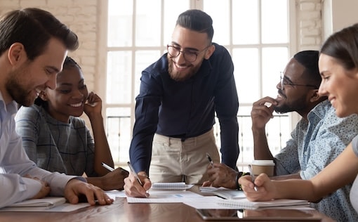 A few people around a table looking at paperwork