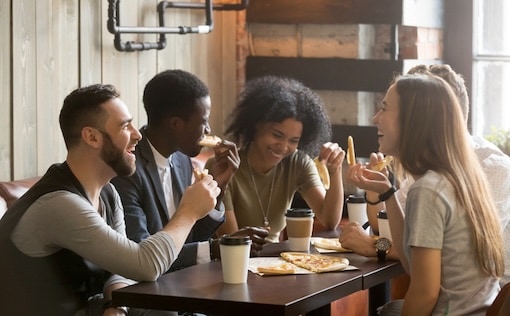 A few people sitting at a table eating