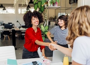 Two women shaking hands