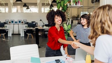 Two women shaking hands