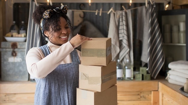 woman in store packing boxes