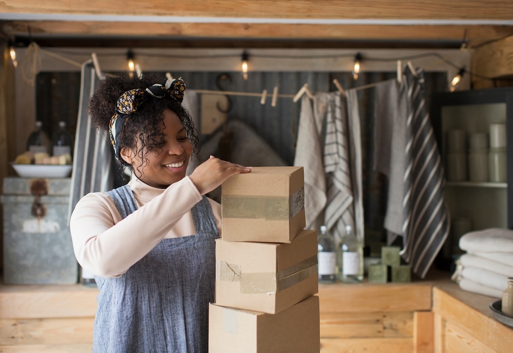 woman standing in store with packing boxes