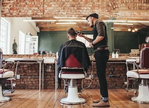 man in barber's chair getting haircut