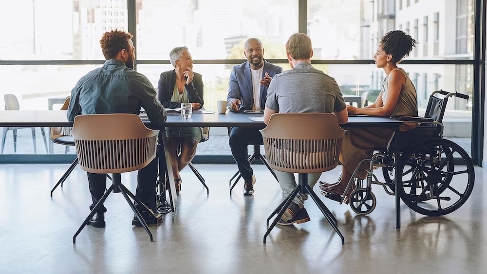People sitting at a conference room table in an office