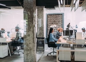 People working at their desk in open floor plan office