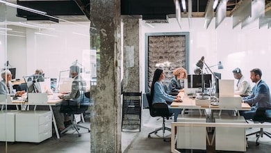 People working at their desk in an open floor plan office