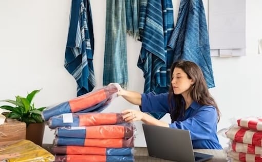 Woman at desk with laptop and inventory