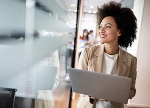 Woman standing with laptop