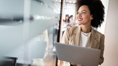 Woman standing with laptop