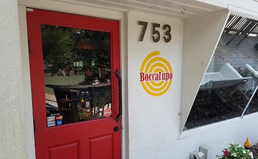 Red door with restaurant sign 