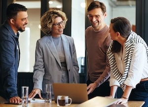Four people standing around a desk