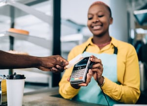 Customer paying at terminal with contactless card