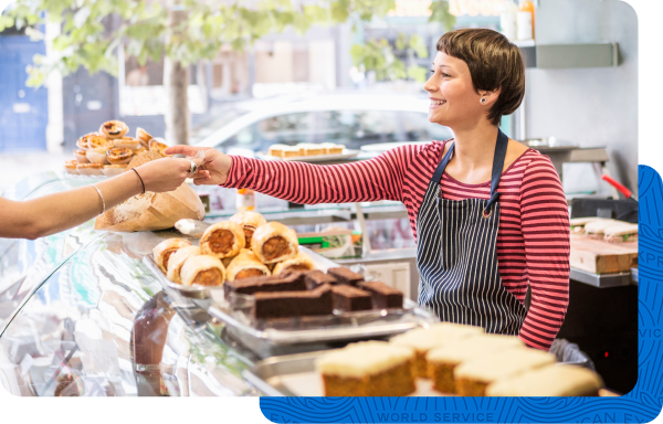 Small business owner selling baked goods to a customer