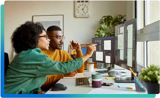 Two people looking at a computer