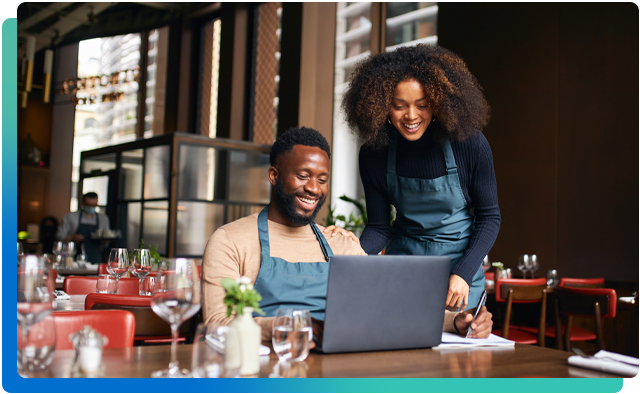 Person using laptop in dining business