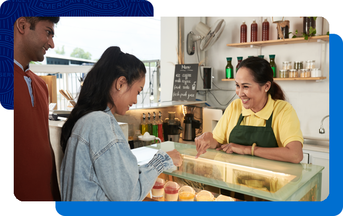 Bakery owner helping customers pick a pastry.