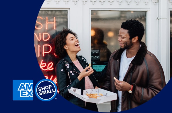 A couple enjoying fish and chips next to a “Shop Small with American Express” logo