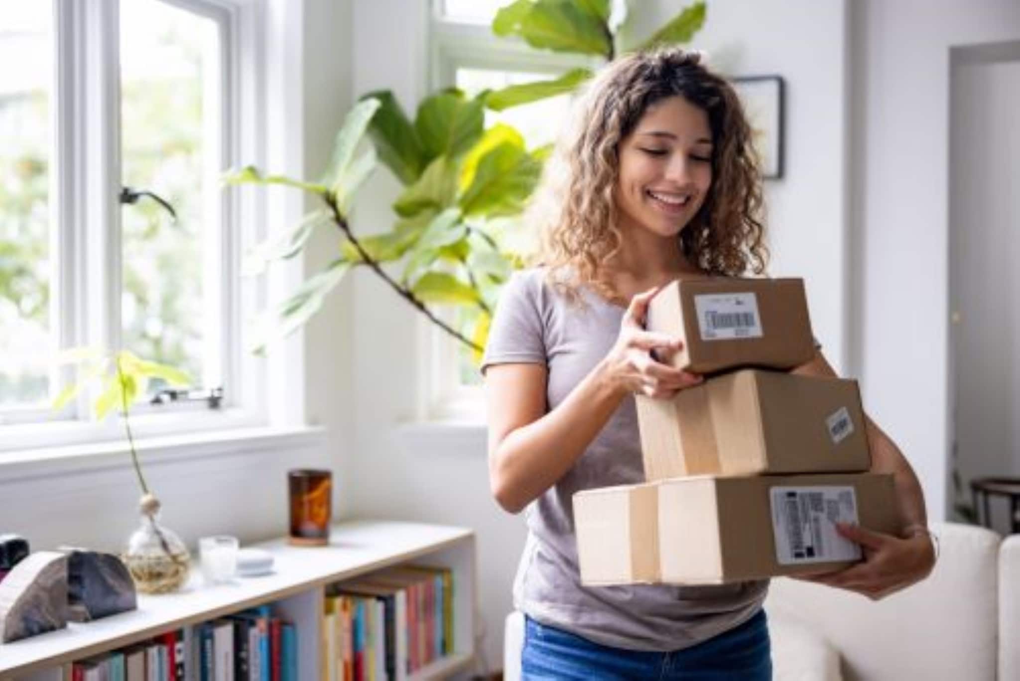 Woman carrying a collection of boxes