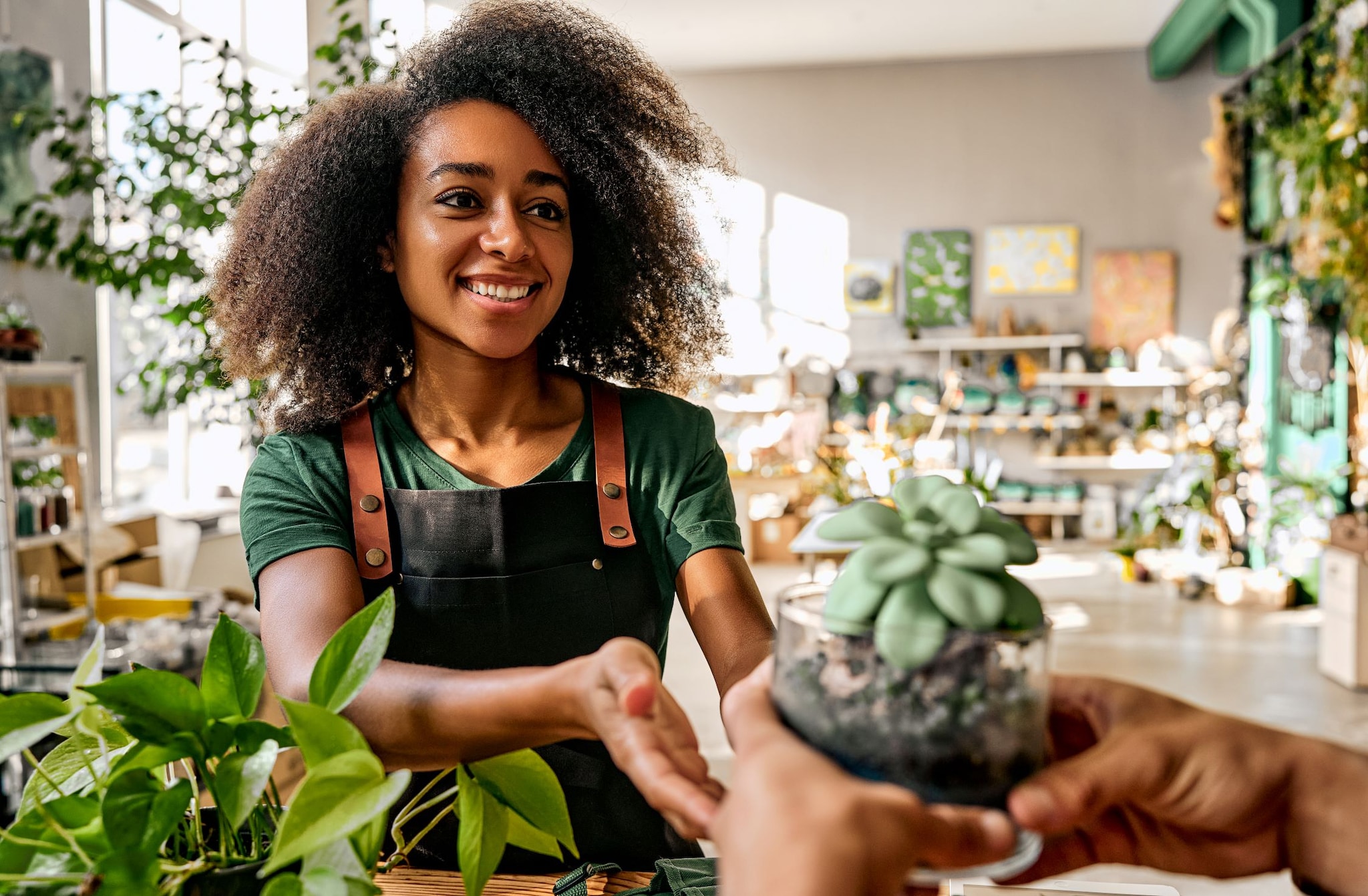 Woman sharing a small plant with a customer