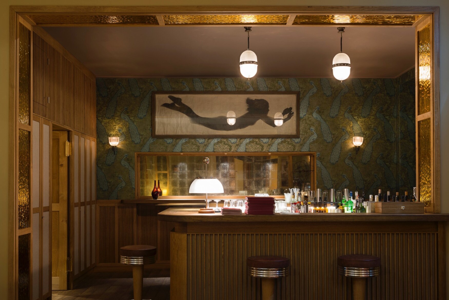 Ein holzverkleideter Tresen in einer modernen Bar mit gedimmter Beleuchtung.