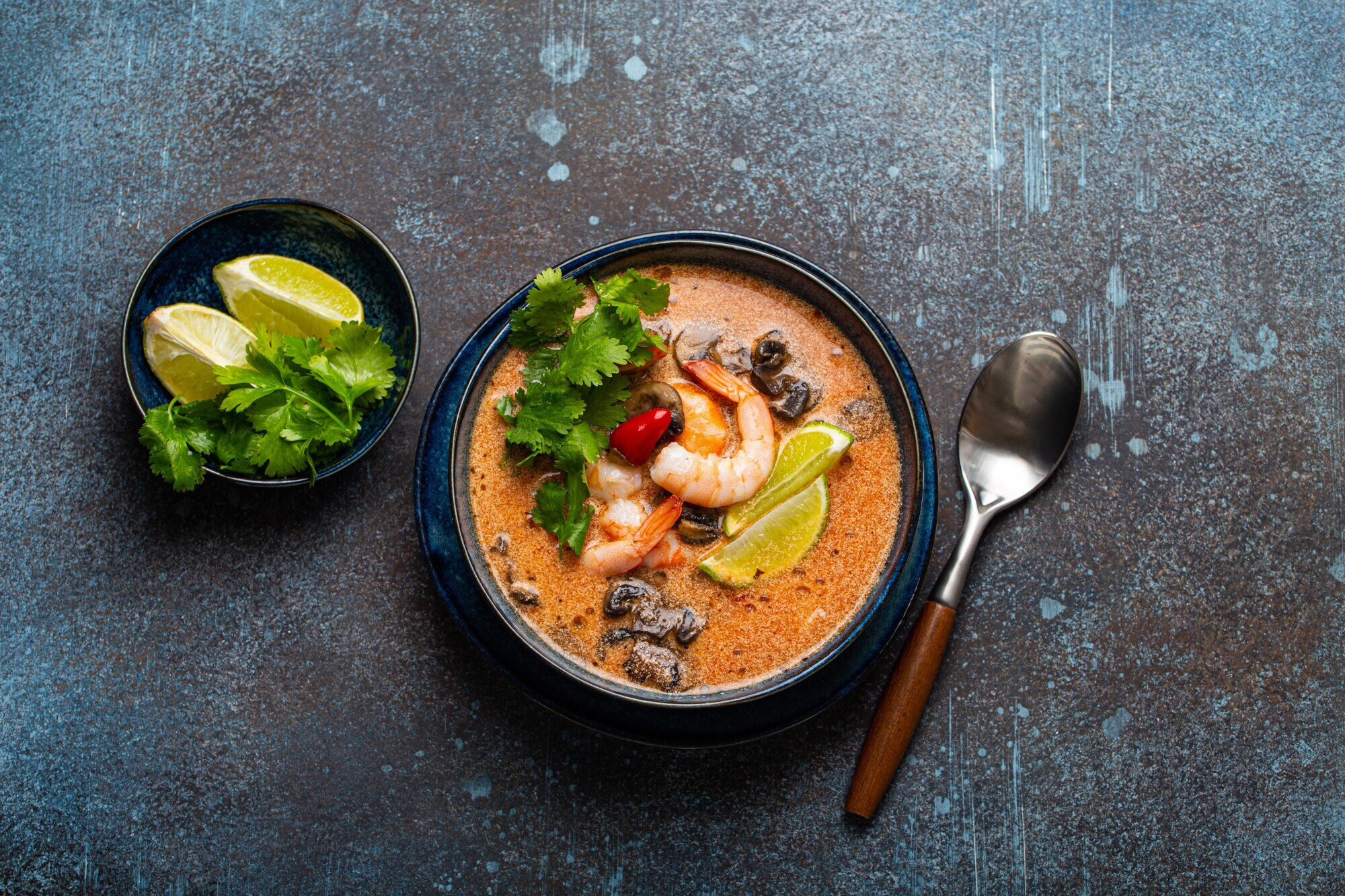 Thai-Suppe Tom Yum mit Meeresfrüchten in einer Keramikschüssel von oben