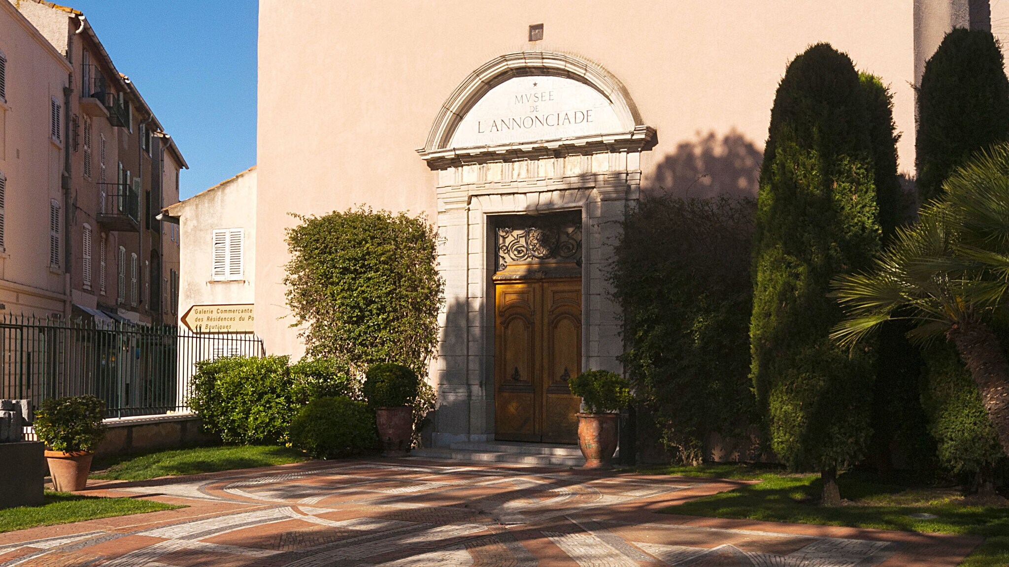 Begrünter Eingangsbereich zu einem Museum in einer Kapelle in einer mediterranen Stadt.