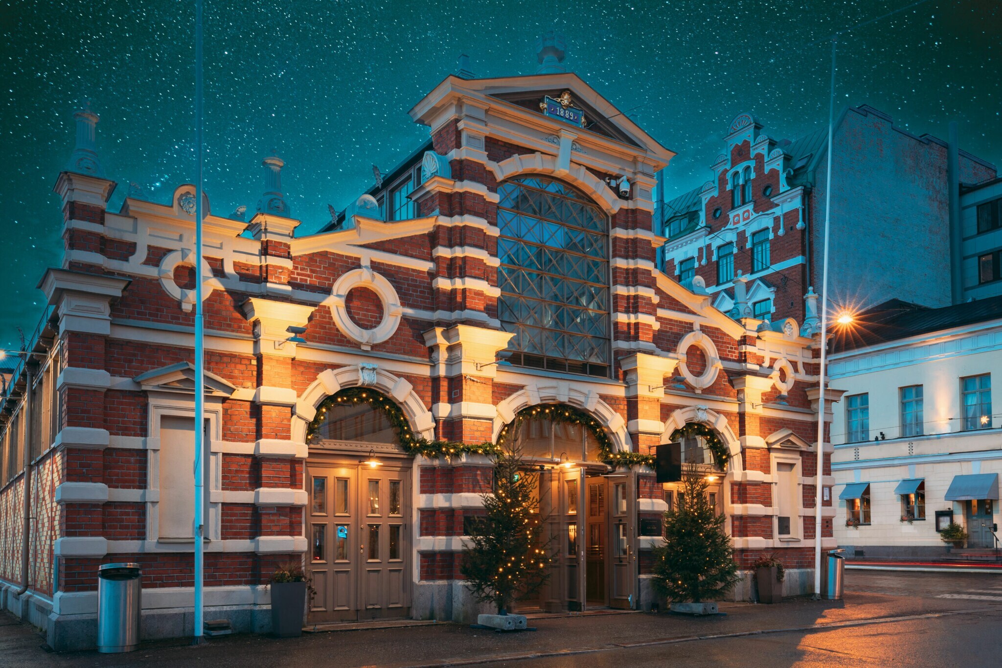 Alte Markthalle in Helsinki mit Abendbeleuchtung und weihnachtlicher Dekoration.